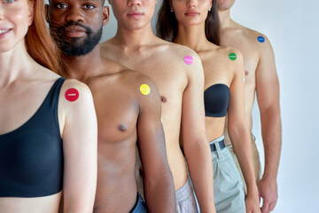 Fototapeta na wymiar black, caucasian and asian people arms after vaccine injection, in line. prevent yourself for coronavirus, omicron, covid-19 disease outbreak in society. focus on black shirtless guy