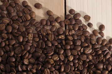 here is a picture of coffee beans on the wooden floor and the sun shines down