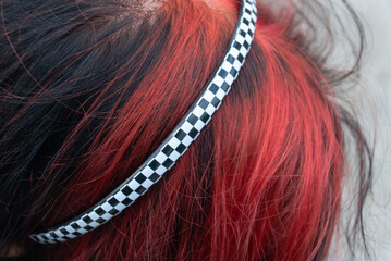 Punk emo girl, young adult with black red hair, close-up, horizontal