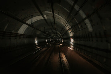 View of subway tunnel from moving underground carriage. Riding Tokyo metro train in metropolitan city. Modern public mode of transport.