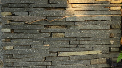 abstract background of textured gray stone wall
