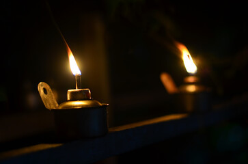 Traditional kerosene lamp light  also known as pelita isolated in a dark background.
