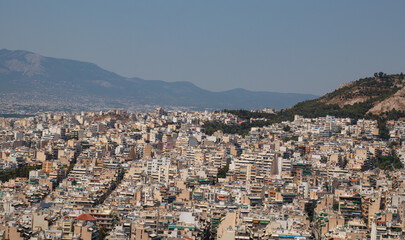 Top view of the city and mountains in summer in haze from the heat, Greece