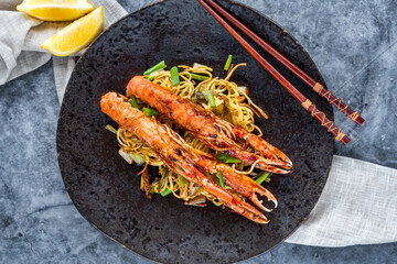 Langoustines with ginger, spring onions and crispy fried egg noodles