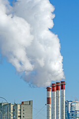 Smoking pipes of a gas boiler house on a winter day