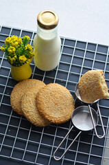 A bottle of milk and low calories sesame biscuits : healthy lifestyle concept (selective focus image)