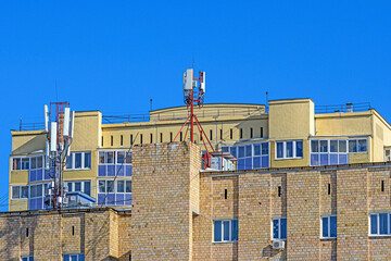 Fototapeta premium Mobile communication equipment on the roof of the building on a winter day