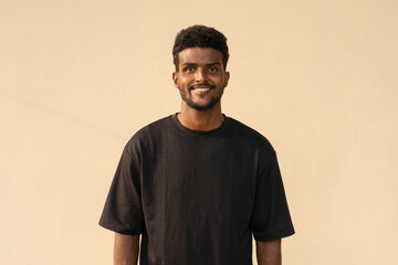 Portrait of handsome African man wearing oversized black t-shirt
