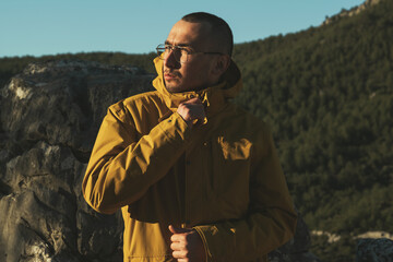 Portrait of a man with glasses and yellow coat