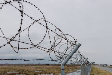 View inside and along the round barbed wire along the road