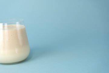Traditional Indian mango lassi drink on a blue background. Copy space.