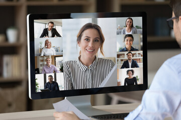 Close up desktop computer screen with webcam conference corporate video chat interface. Diverse...