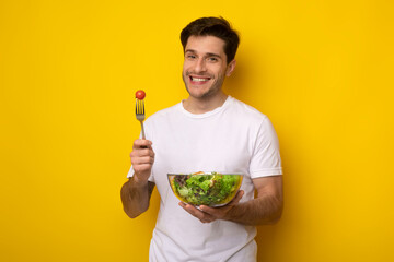 Portrait of Smiling Guy Holding Plate With Healthy Salad