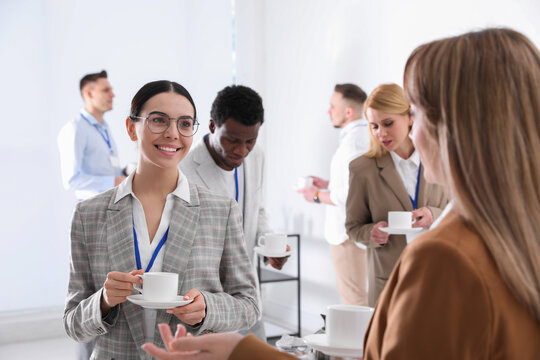 Group Of People Chatting During Coffee Break Indoors