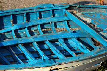 Old abandoned derelict punt boat on a seashore