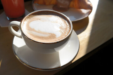 a cup of coffee on a sunny table