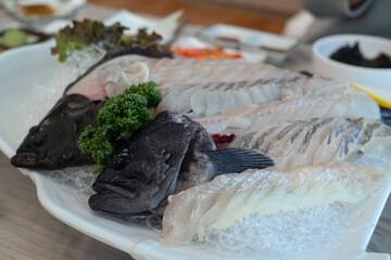 Fresh halibut and rockfish that is filleted, sliced thinly, and served raw.