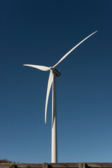 Windmill on a sunny day with a blue sky as a minimal background