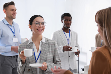 Group of people chatting during coffee break indoors