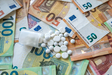 different pills on euro bills as background