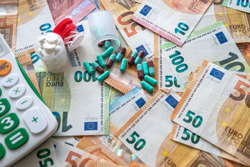  Euro banknotes money with calculator and capsule