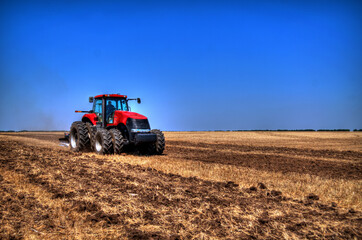 Tractor plowing in the field