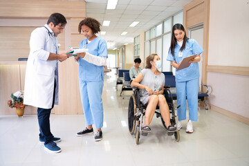 Doctor and nurse is working in hospital ward while explaining care plan for patient and having...