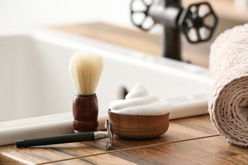 Male accessories for shaving on table in bathroom