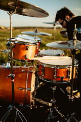 Fototapeta na wymiar A south spain drummer man playing in a field at sunset very hard