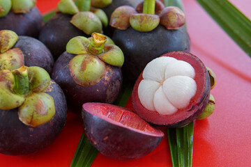Pile of ripe mangosteen on wooden table background.