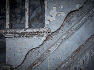 Staircase details and peeling paint in an abandoned home