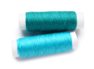 Different thread spools on white background