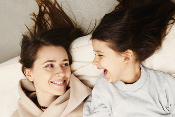 Fototapeta na wymiar Mother with her daughter enjoy in bed