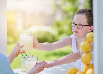 Here you go - enjoy. Cropped shot of a little girl selling lemonade from her stand outside.