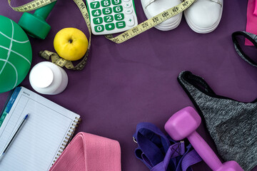 sports equipment in the form of water balls dumbbell notebook and handles lie on the floor.