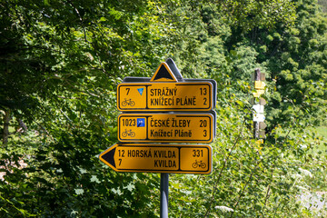 Signposting of Czech cycle routes, yellow signs with location and cycle route number, in the Šumava Czech Republic