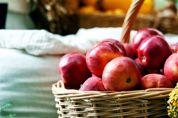 Lots of red apples in a wicker basket at a village fair. Rural food and agriculture concept.
