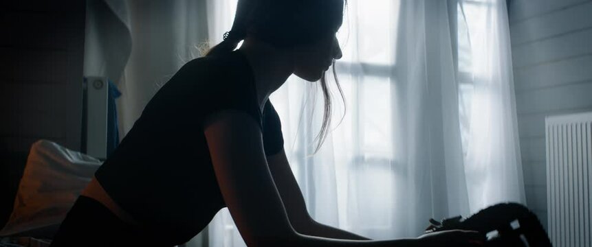 CU Portrait of attractive Caucasian teenager girl playing baseball catch with herself in her bedroom at home. Shot with 2x anamorphic lens