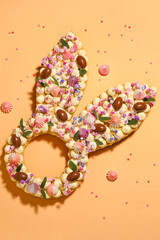 Beautiful cake and meringue for Easter celebration on orange background