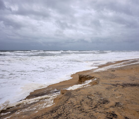 Foam surf washed up on an Outer Banks beach in North Carolina during a storm