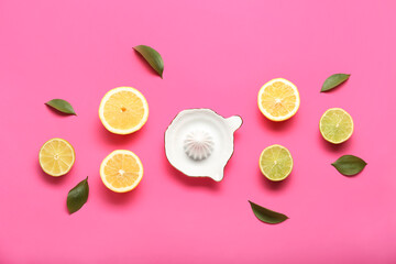 Ceramic juicer, cut lemons and limes on pink background