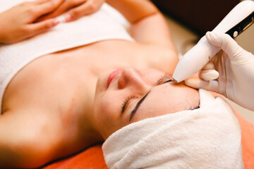 Closeup facial liposuction spa on young woman face in spa.