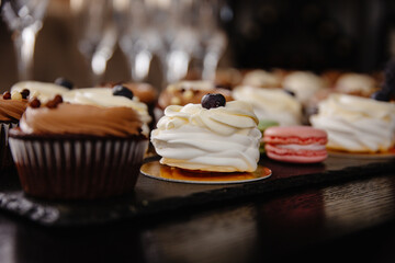 cupcakes with chocolate icing, tasty desserts on the table.