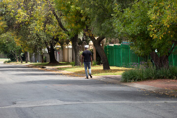 Fototapeta na wymiar Black African Man walking down the road
