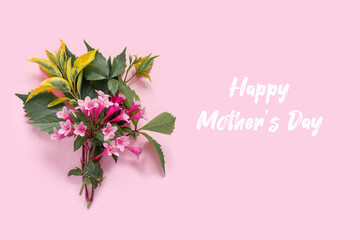 Fototapeta premium Greeting card with pink weigela flowers for mother's day. Creative design with copy space and text.