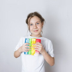 child girl holding colorful garbage bags. the concept of sorting garbage for recycling.environmental education for children.Red - waste that is disposed of irretrievably,Blue  waste paper,Green  glass