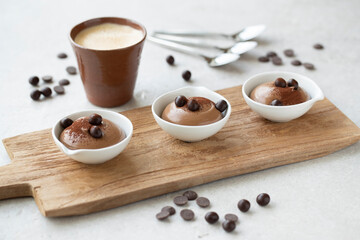 three cups of chocolate mousse and coffee