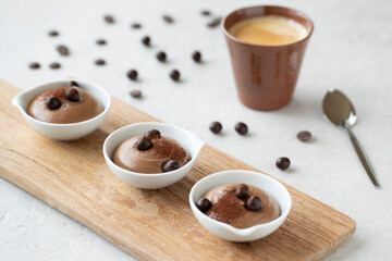 three cups of chocolate mousse and coffee
