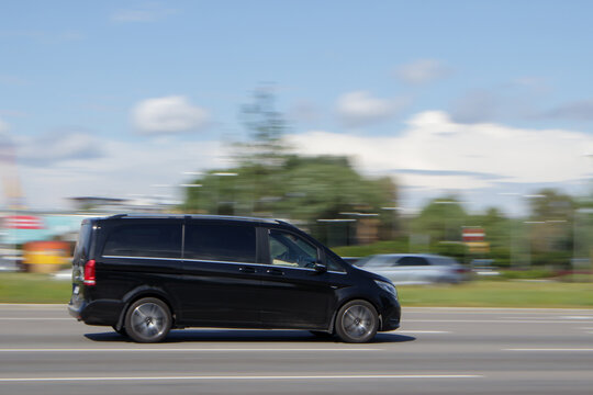 A black passenger Mercedes V-Class minivan drives on the road. Motion blur. Riga, Latvia - 28 Jun 2021.