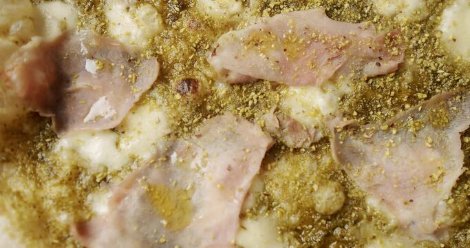 Tasty Pizza with Cheese and Parmesan. Pizza with Meat, Pesto, Cheese and Parmesan fresh out of the oven ready to eat. Delicious Italian pizza. Napoli Pizza. Food Service on white table and ingredient.